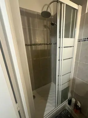 a shower with a glass door in a bathroom at Studio Rue Bonaparte in Nice