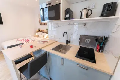a small kitchen with a sink and a counter at Nice Port studio avec grande baignoire in Nice