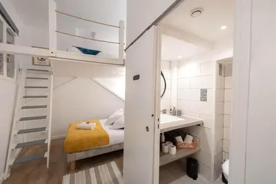a small bedroom with a bunk bed and a sink at Studio 4 couchages in Nice