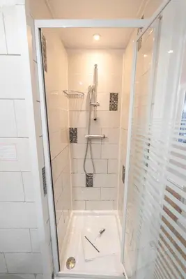 a bathroom with a shower with a glass door at Studio 4 couchages in Nice