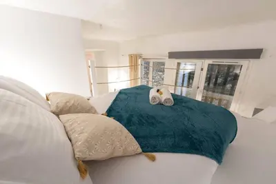 a white couch with a blue blanket and pillows at Studio 4 couchages in Nice
