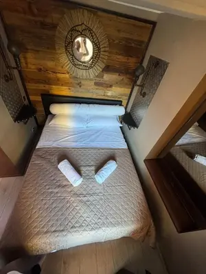 an overhead view of a bed with slippers on it at Beautiful apartament 2 pièce Nice center in Nice