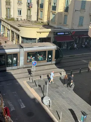 a balcony with two tables and a vase of flowers at Beautiful apartament 2 pièce Nice center in Nice