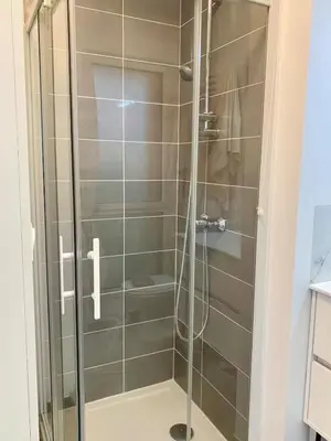 a shower with a glass door in a bathroom at Modern Studio by Port & Old Town in Nice
