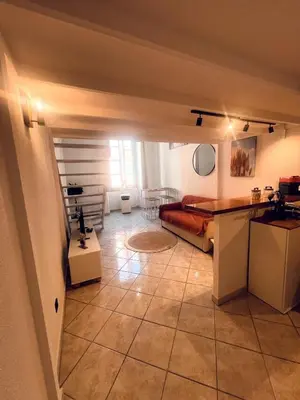 a bedroom with a bed and a tiled floor at Duplex Place Massena in Nice