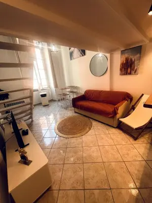 a living room with a couch and a table at Duplex Place Massena in Nice