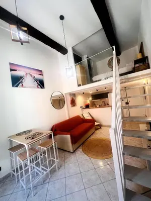 a living room with a red couch and a table at Duplex Place Massena in Nice