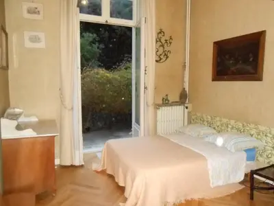 a bedroom with a bed in front of a window at Une chambre chez l'habitant a Nice - Cimiez in Nice