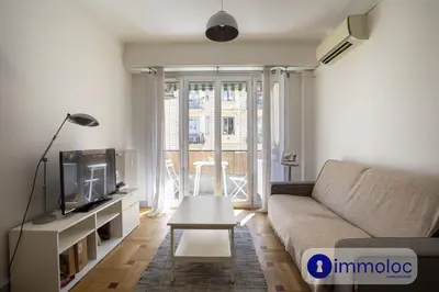 a living room with a couch and a tv at Apartment neighborhood Liberation in Nice