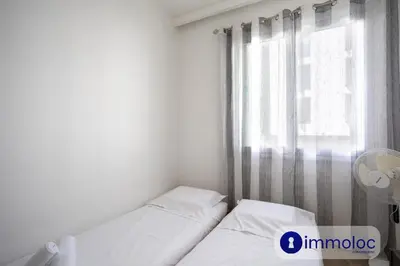 a small bedroom with two beds and a window at Apartment neighborhood Liberation in Nice
