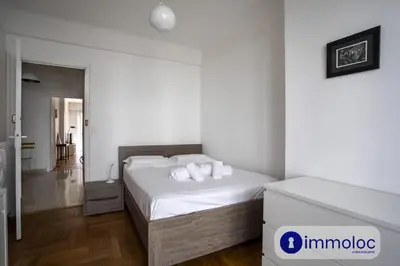 a bedroom with a bed with white sheets and pillows at Apartment neighborhood Liberation in Nice
