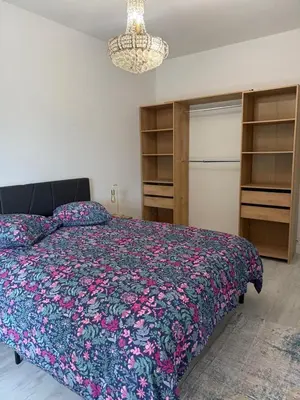 a bedroom with a bed with a colorful comforter at Beautiful 3 bedroom apartment with nice garden in Nice