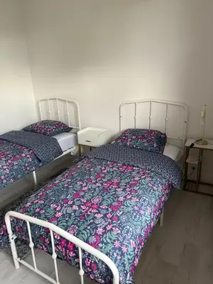 two beds sitting next to each other in a bedroom at Beautiful 3 bedroom apartment with nice garden in Nice