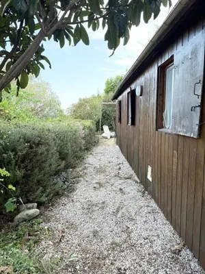 a dirt path next to a building with a window at Charmant chalet avec jardin in Nice