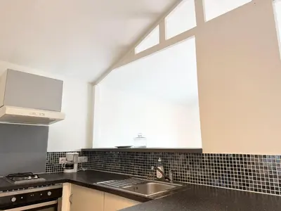 a kitchen with a sink and a window at Charmant chalet avec jardin in Nice