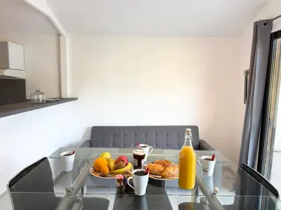 a table with a plate of fruit and a bottle of orange juice at Charmant chalet avec jardin in Nice