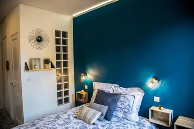 a bedroom with a blue wall and a bed at Studio port de Nice in Nice