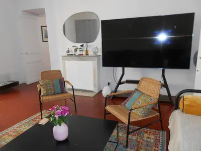 a living room with a large flat screen tv at Exceptional Location Beaches Cours SALEYA in Nice