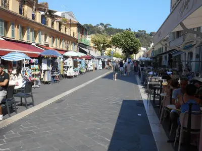 a street with shops and people walking down the street at Exceptional Location Beaches Cours SALEYA in Nice