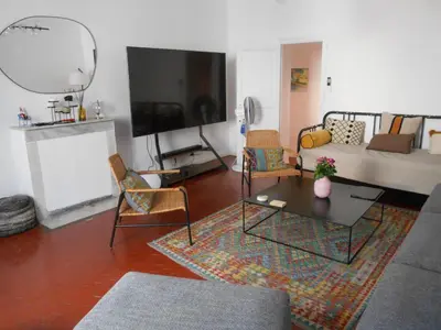 a living room with a couch and a table at Exceptional Location Beaches Cours SALEYA in Nice