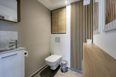 a small bathroom with a toilet and a sink at Les Vagues du 5e 4 personnes , 2 chambres , clim , wifi , Cap3000 à pied , parking in Saint-Laurent-du-Var