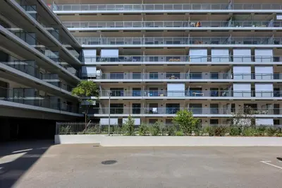 an empty parking lot in front of an apartment building at Les Vagues du 5e 4 personnes , 2 chambres , clim , wifi , Cap3000 à pied , parking in Saint-Laurent-du-Var