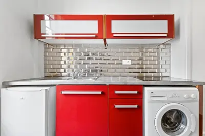 a kitchen with red cabinets and a washing machine at Nice Renting - PAGANINI - New Lovely Cosy Flat in Heart of Nice in Nice