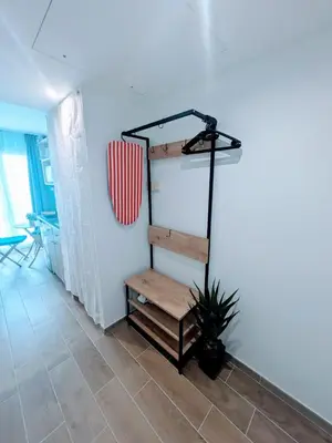 a room with a stair case and a bench at Studio avec balnéo proche plage in Nice