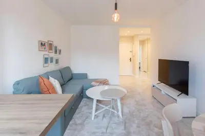 a living room with a blue couch and a tv at L3- 2P Clémenceau, centrale, 10 min place Massena-AC in Nice