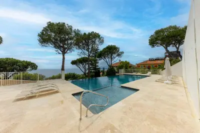 a swimming pool with a view of the ocean at Superb apartment with exceptional sea view in Nice