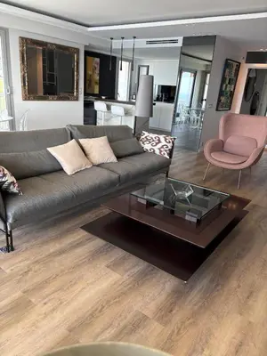 a living room with a couch and a coffee table at Superb apartment with exceptional sea view in Nice
