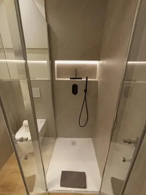 a bathroom with a shower with a sink and a toilet at Superb apartment with exceptional sea view in Nice