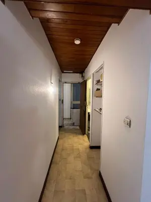 a hallway with a white wall and a wooden ceiling at T2 Pasteur in Nice