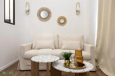 a living room with a couch and a table at WeHost D2 - Smart & chic loft, 3 mins to beaches in Nice