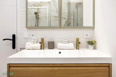 a kitchen with a table and chairs and a television at WeHost D2 - Smart & chic loft, 3 mins to beaches in Nice