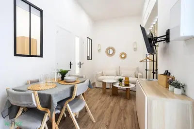 a dining room with a table and chairs in a living room at WeHost D2 - Smart & chic loft, 3 mins to beaches in Nice