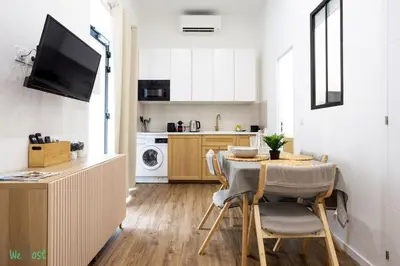a living room with a couch and a table at WeHost D2 - Smart & chic loft, 3 mins to beaches in Nice