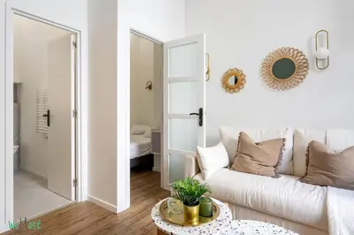 a living room with a couch and a table at WeHost D4 - La Chic Cour 2 people Near sea in Nice