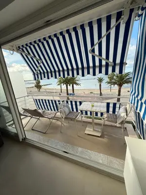 a view of a patio with chairs and a table at Le Cormoran bord de mer in Saint-Laurent-du-Var