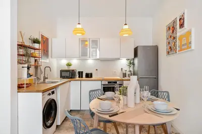 a kitchen and dining room with a table and chairs at Nice Renting - COLLET - Cocoon Design Old Nice Beach Massena Saleya in Nice