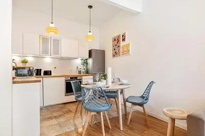 a kitchen and dining room with a table and chairs at Nice Renting - COLLET - Cocoon Design Old Nice Beach Massena Saleya in Nice