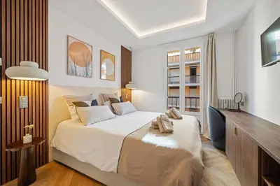 a bedroom with a large bed and a television at luxueux, spacieux dans le quartier du port in Nice