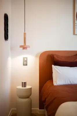 a bedroom with a bed and a table with a lamp at luxueux, spacieux dans le quartier du port in Nice