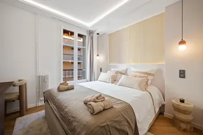 a bedroom with a large bed with towels on it at luxueux, spacieux dans le quartier du port in Nice