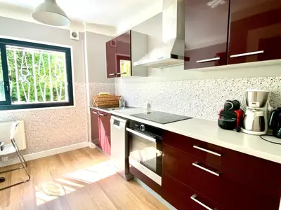 a kitchen with a sink and a stove top oven at Villa Nice Côte d'Azur piscine privée rez de chaussée in La Gaude