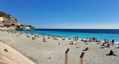 a large group of people on a beach at Central & Beach in Nice