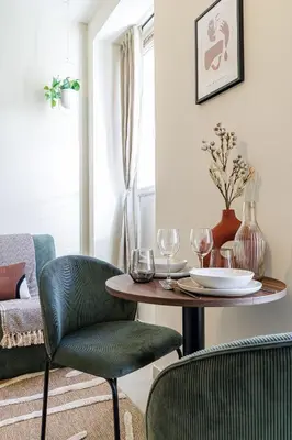 a dining room with a table and two chairs and a table at 44 LAMARTINE - Charmant 2 pieces - Centre-ville in Nice