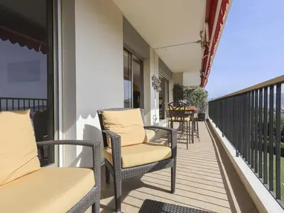 a balcony with two chairs and a table on a balcony at Apartment Le Sirius by Interhome in Nice