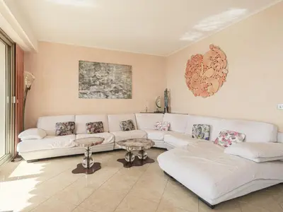 a living room with a white couch and tables at Apartment Le Sirius by Interhome in Nice