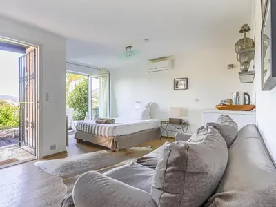 a living room with a couch and a bed at Holiday Home Les Genêts by Interhome in Nice